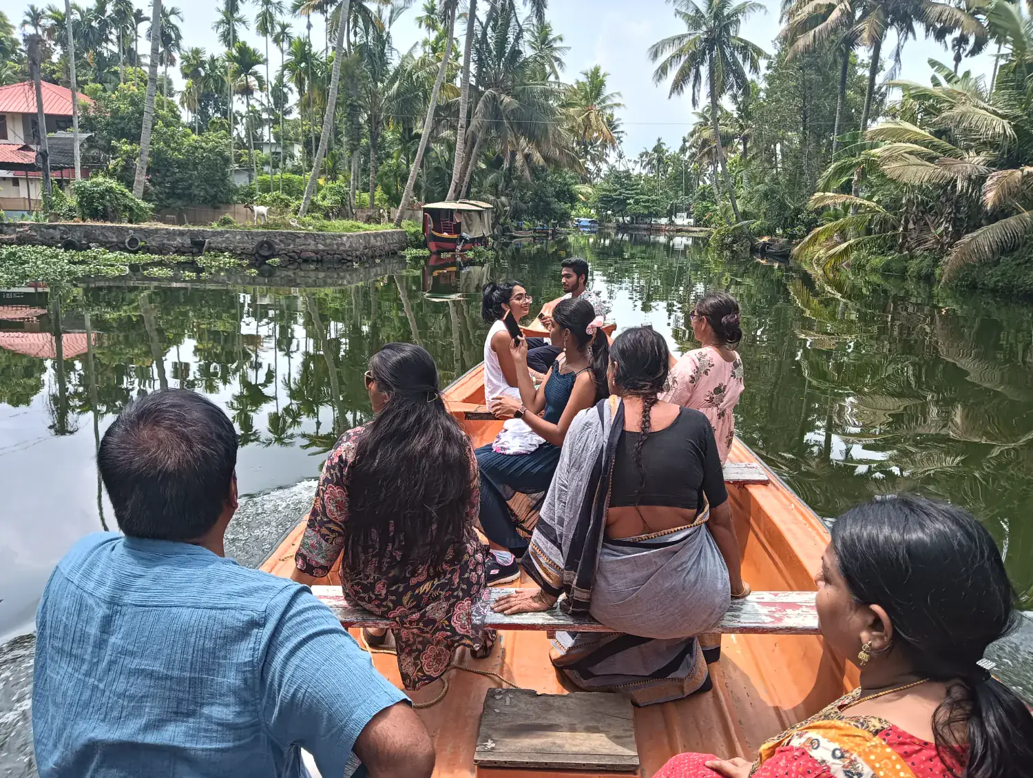 Group exploring a quiet Alleppey canal by canoe