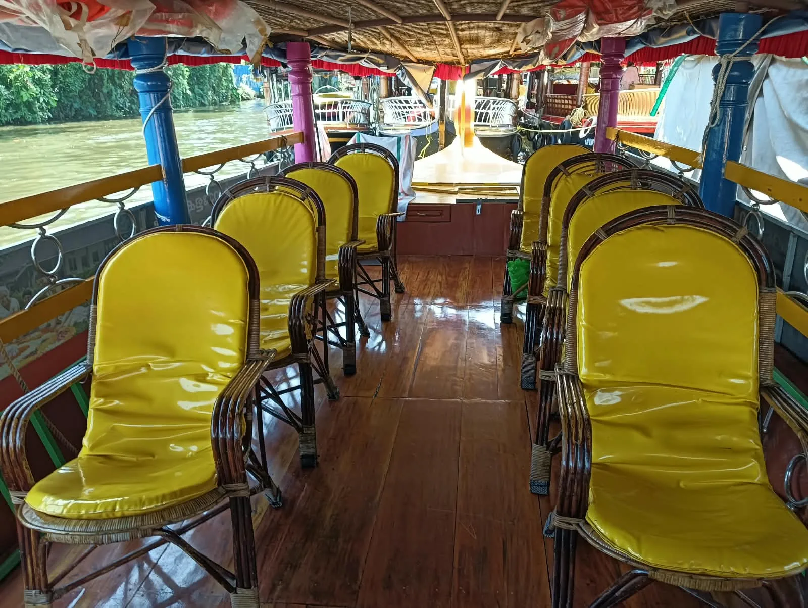 Yellow cushioned chairs inside the client’s Shikara boat