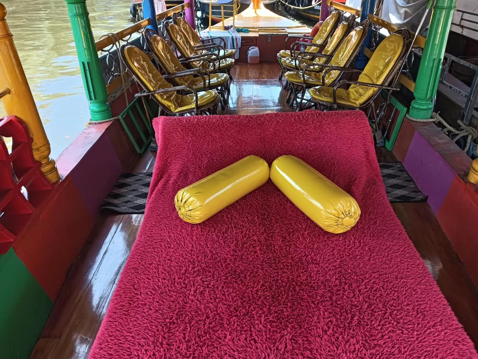 Red cushioned seating area inside the client’s Shikara