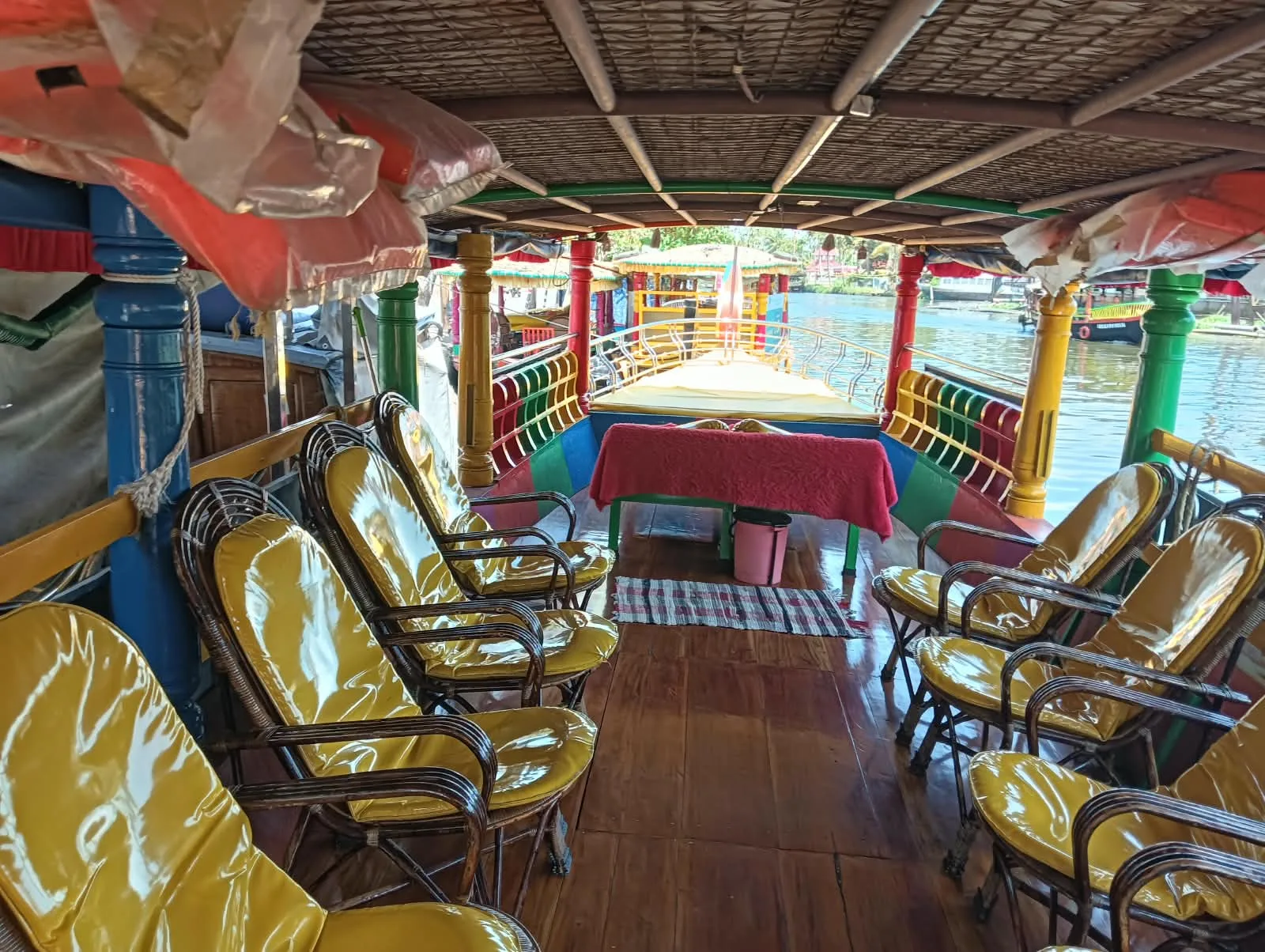 Wicker seating inside the colourful open-sided Shikara